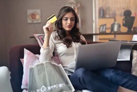 woman-holding-card-while-operating-silver-laptop-919436.jpg